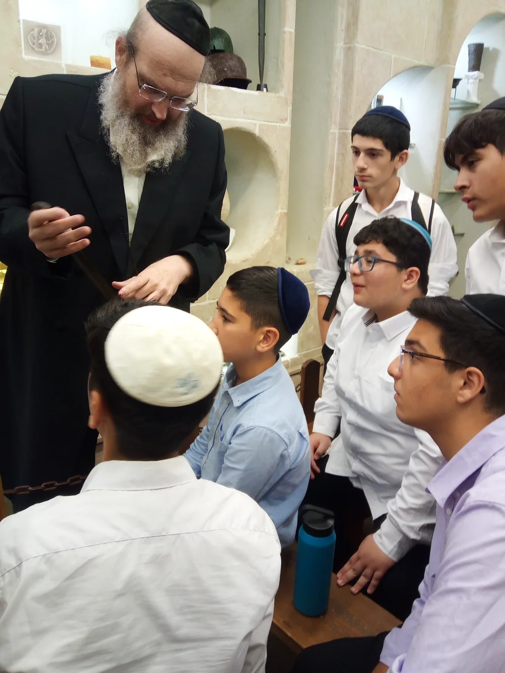 Students observing a close-up demonstration during an educational visit